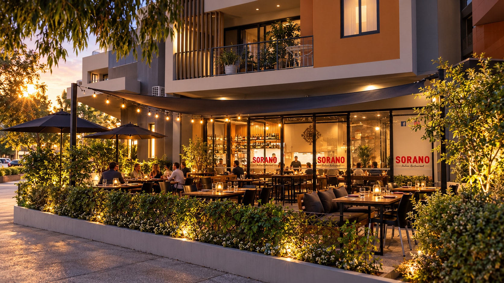Sorano at golden hour: guests dining in the lantern-lit courtyard under festoon lights, with red SORANO lettering glowing on the windows